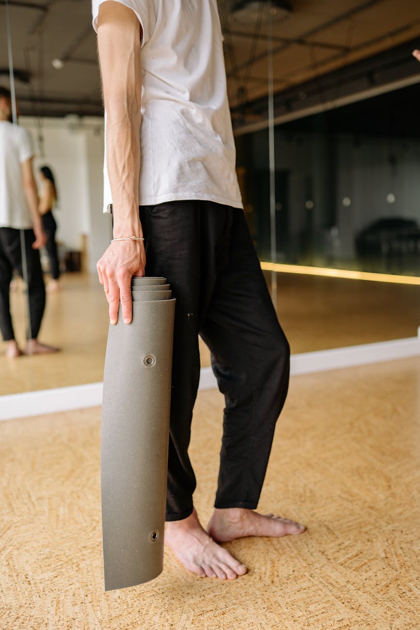 A man holding a difficult balance pose demonstrating core strength and concentration.
